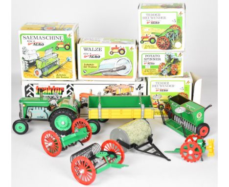 Kovap tinplate clockwork tractor made in the Czech Republic, together with five tow along accessories, all in original boxes.