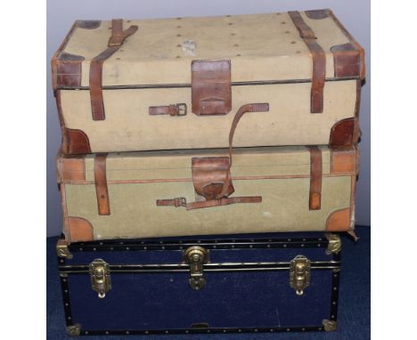 Three vintage metal / leather bound trunks / cases, the canvas examples by Bick of Cheltenham, with ash runners and luggage l