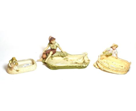 Three post 1919 Royal Dux figural dishes, largest 32cm wide 