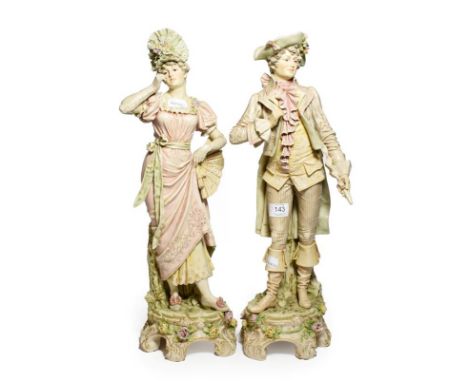 A pair of post 1919 Royal Dux figures of courtiers in 18th century dress, model numbers: 93 &amp; 94, 54cm high 