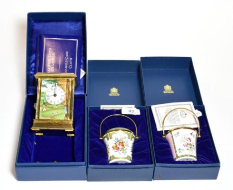 A Halcyon Days enamel carriage timepiece and two Halcyon Days enamel buckets (3).  Models in good condition, with no obvious 