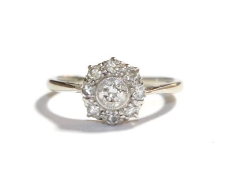 A diamond cluster ring, stamped '18CT' and 'PLAT', estimated diamond weight 0.50 carat approximately, finger size J1/2.  Gros