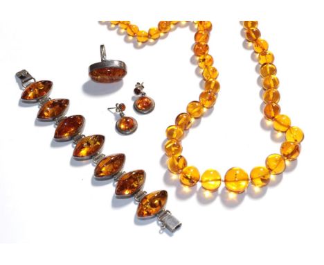 An amber type suite comprising a necklace, a bracelet, a ring and a pair of drop earrings .  All mounts stamped '925'. Gross 