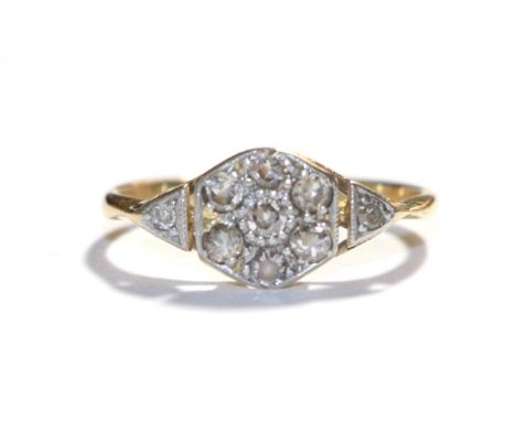 A diamond cluster ring, stamped '18CT', finger size J.  Gross weight 1.7 grams. 