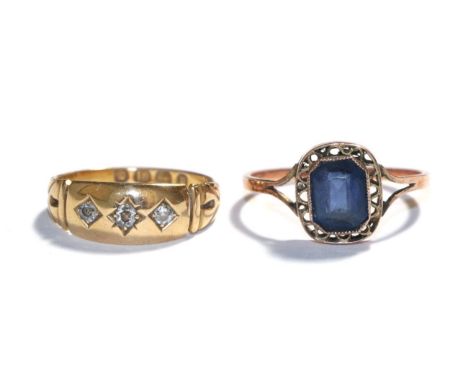 An 18 carat gold diamond three stone ring, finger size L and a gem set ring, indistinctly marked, finger size Q1/2.  Diamond 