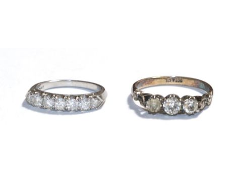 A diamond seven stone ring, stamped 'PLAT, finger size K' and a paste three stone ring, stamped '9CT&amp;SIL', finger size R1