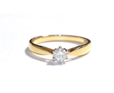 An 18 carat gold diamond solitaire ring, the round brilliant cut diamond in a white claw setting to a tapered shoulder plain 