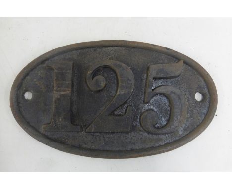 An oval cast iron plaque no. 125.
