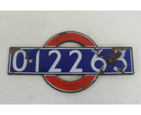 An unusual small enamel sign, no. 012263, with red circle behind, from a 1938 stock trailer car, 5 1/2 x 3".