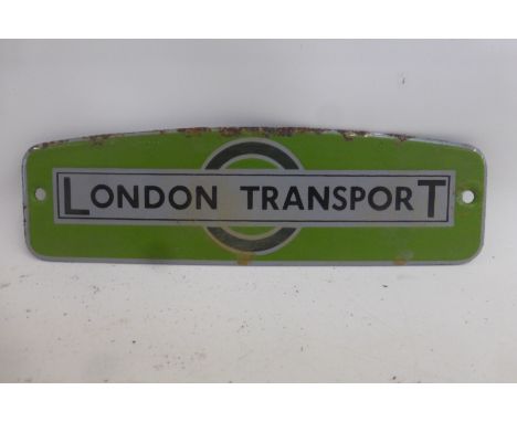 A London Transport shaped enamel plaque, 7 1/2 x 2 1/4".
