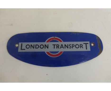 A London Transport shaped enamel plaque, 8 3/4 x 3".