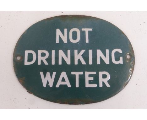 An oval enamel plaque - Not drinking water, with label to reverse, by repute from Seaton, Devon, 5 1/4 x 3 3/4".