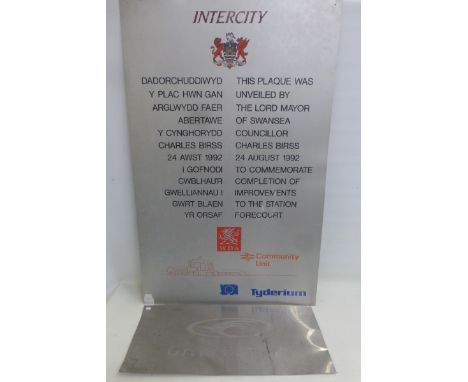 A large Intercity Railway sign both in Welsh and in English describing a commemorative plaque for the forecourt station unvei