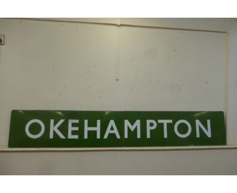 A large two piece enamel station sign for Okehampton, 145 x 24".