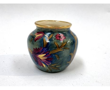 A Moorcroft enamel miniature vase, purple floral pattern, 5cm tall