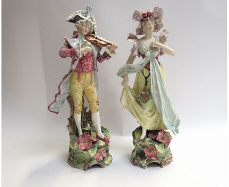 A pair of late 19th/early 20th Century ceramic figures, 38.5cm and 40cm tall