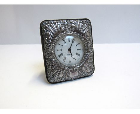 A silver embossed easel-back clock with Roman numerated dial, 11.5cm x 10cm
