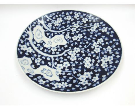 An early 20th Century Chinese porcelain wall charger with deep blue ground and allover blossoming tree design in white, 46cm 