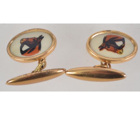 A pair of gold tone and enamel cufflinks with pictures of horses.