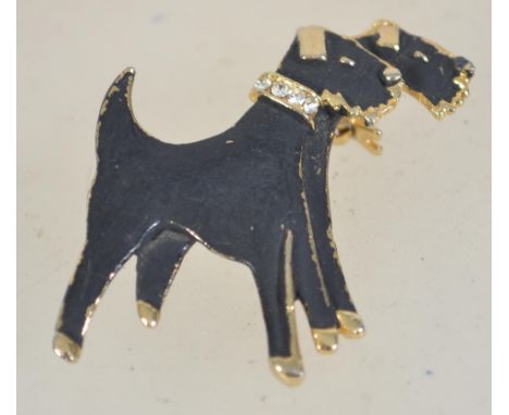 A vintage yellow tone metal enamel and rhinestone figural brooch in the form of two terriers having a roller clip clasp. Meas