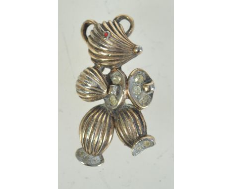 A 1960s goldtone metal and rhinestone brooch in the form of a stylised teddybear playing cymbals having rollover catch. Measu