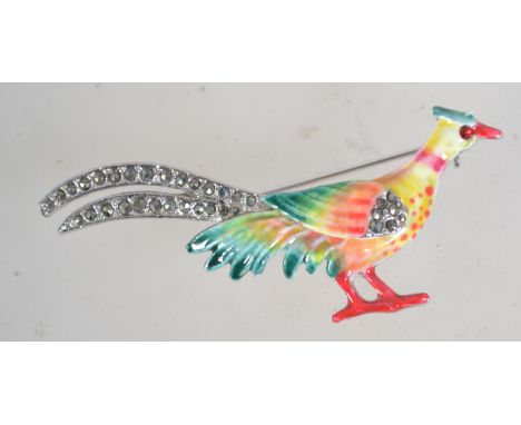 A vintage silver tone and enamel brooch in the form of a pheasant with marcasite set feathers and roller clip clasp. Measures