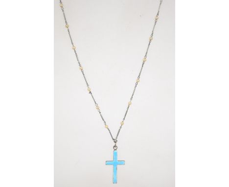A white metal enamel and seed pearl crucifix pendant necklace marks to crucifix. Measures  23 inches.