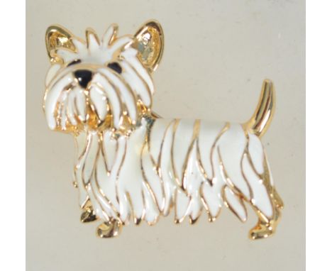 A vintage gold tone and enamel brooch in the form of a terrier dog with roller clip clasp. Measures 3.5 cms.