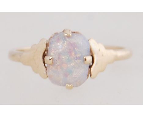 A 9ct gold ring marked 9ct set with an opal style stone. Size M.5. Tests 9ct gold.