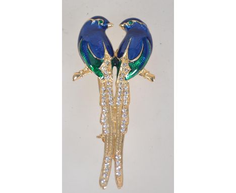 A vintage gold tone enamel and rhinestone figural brooch in the form of two birds of paradise with roller clip clasp. Measure