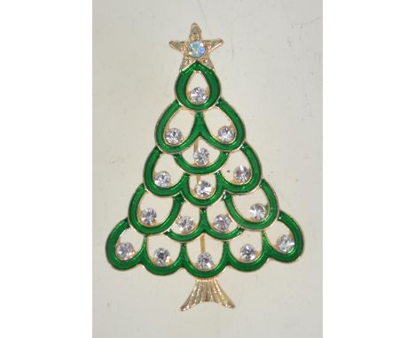 A vintage enamel and rhinestone Christmas tree brooch in gold tone metal with a rollover catch. Measures 5cms