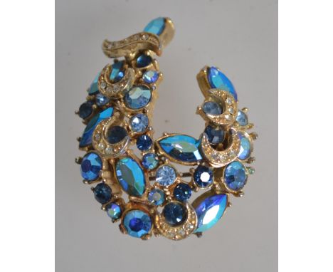 A vintage peacock blue AB rhinestone set brooch pin signed Sphinx with roller clip clasp. Measures 5cms.