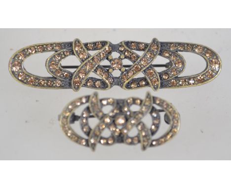 Two white metal  rhinestone set brooches with roller clasps. Measures  5.5cms and 3.5 cms