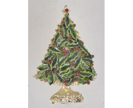 A vintage enamel and rhinestone Christmas brooch in the form of a Christmas tree made of holly with rollover catch. Measures 