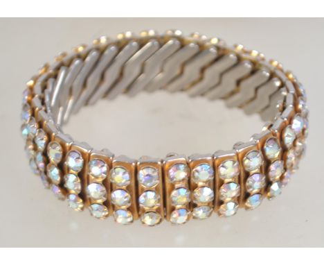 A vintage concertina AB rhinestone set bangle bracelet marked Empire Made.