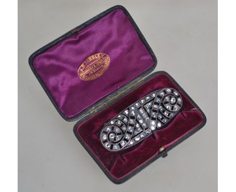 A white metal and marcasite style rhinestone brooch with roller clasp. Measures 7 cms. With vintage presentation box.