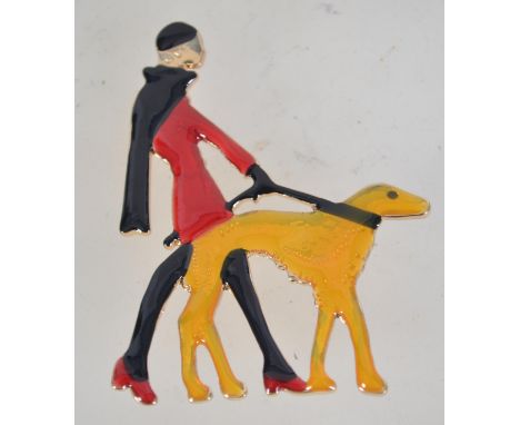 A vintage enamel Art deco style figural brooch pin in the form of a lady walking a bolshoi dog with roller clip clasp. Measur