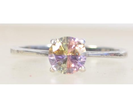 A silver ring set with an unusual four colour quartered CZ stone. Marked 925 CZ size M.5.