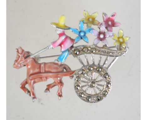 A 1950s enamel and marcasite brooch in the form of a horse and flower cart with rollover catch. Measures 4.8cms.