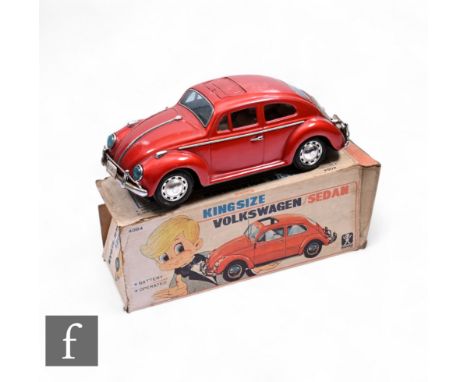 A Bandai battery operated tin plate Volkwagen Beetle car, red body, bump n go action, boxed.