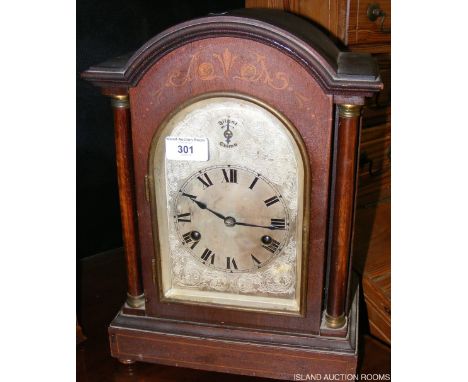 An Inlaid striking mantel clock with silvered dial