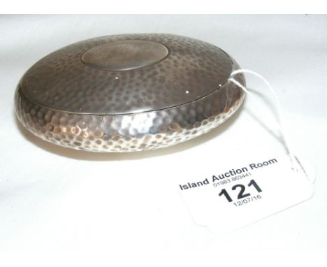 An oval silver snuff box with hammered decoration
