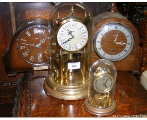 A Kundo mantel clock under glass dome, together with three other clocks