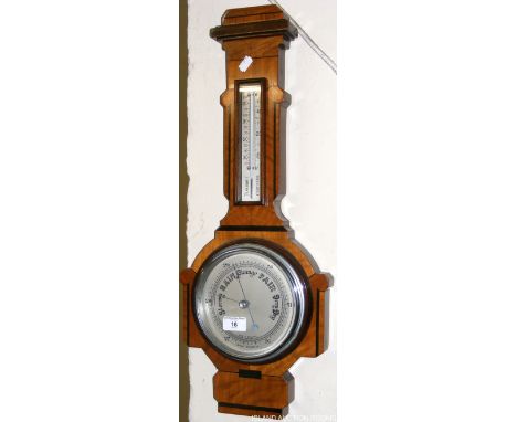 A walnut and ebonized aneroid barometer/thermometer