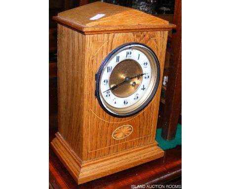 A light oak cased mantel clock with two train movement - 28cm