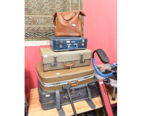 A group of five vintage suitcases and satchels