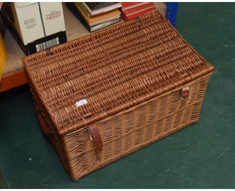 A large wicker picnic hamper
