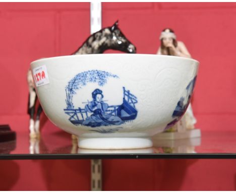 A Chinese porcelain bowl with incised decoration and vignettes displaying ladies, decorated to the well with children playing