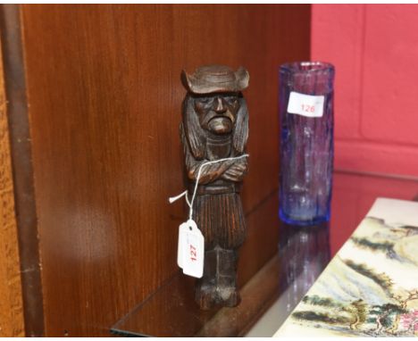A late 19th/early 20th century French carved nutcracker modelled as a Breton man with arms crossed wearing a hat and traditio