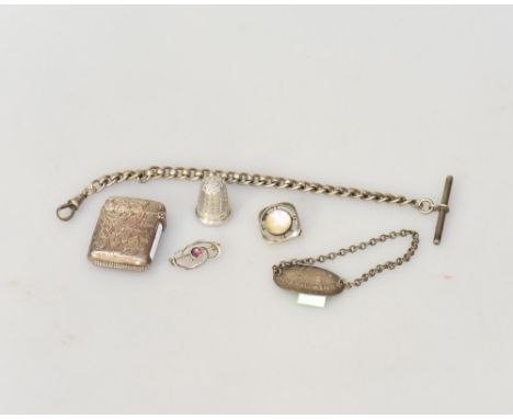 A group of silver comprising a thimble, an identity tag, an engine turned lighter, an Albert, two brooches